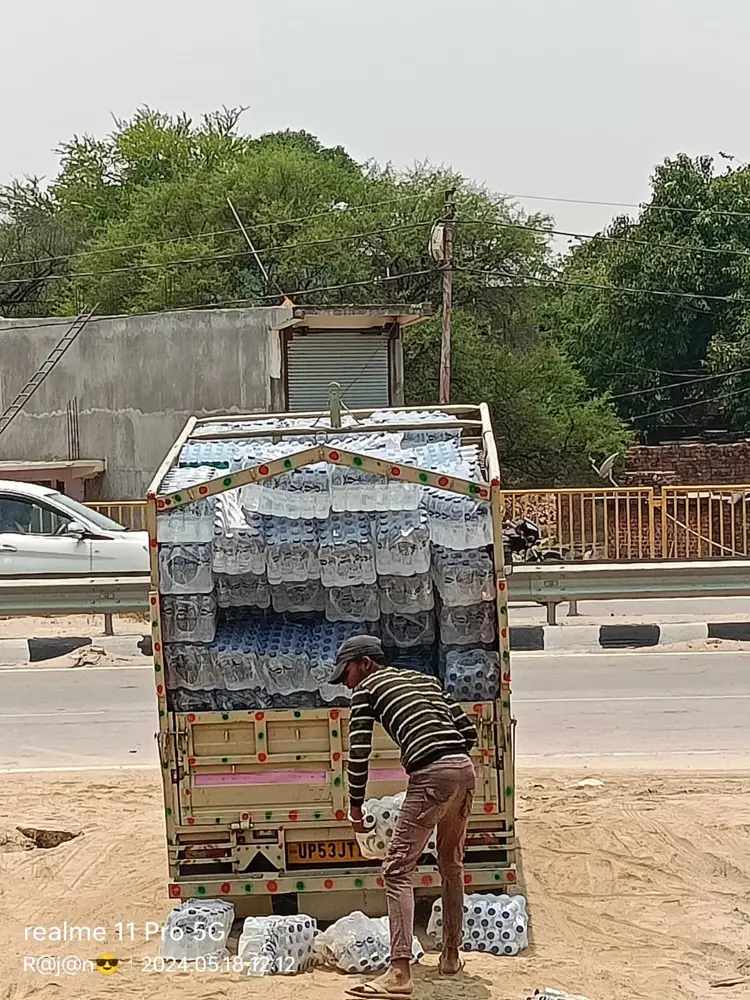 Anexo delivery vehicle being loaded with water packs